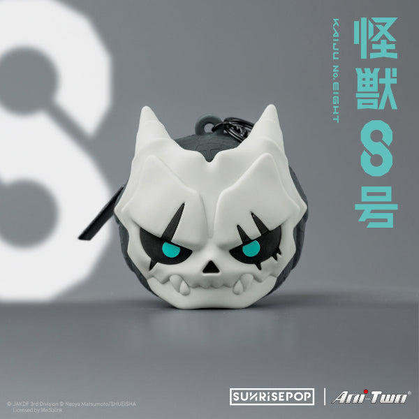 Collection of new Kaiju No.8 merchandise, including a Kaiju No.8 shaped silicone pouch, stackable storage boxes, and acrylic glitter blocks, badges, and standees, with a Kaiju No.8 themed background.